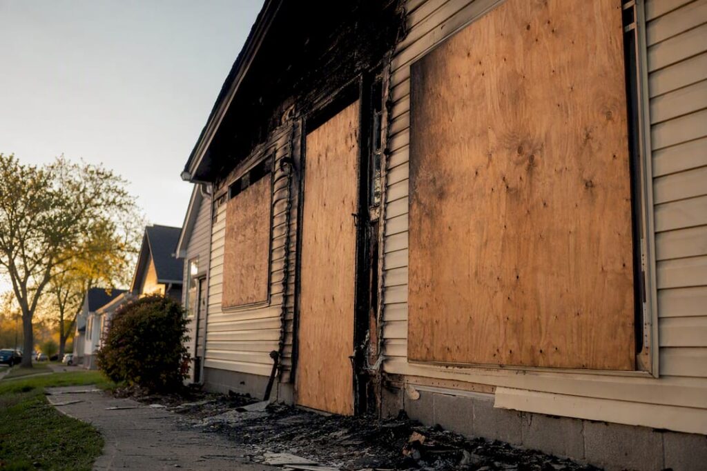 Boarded fire damaged house exterior