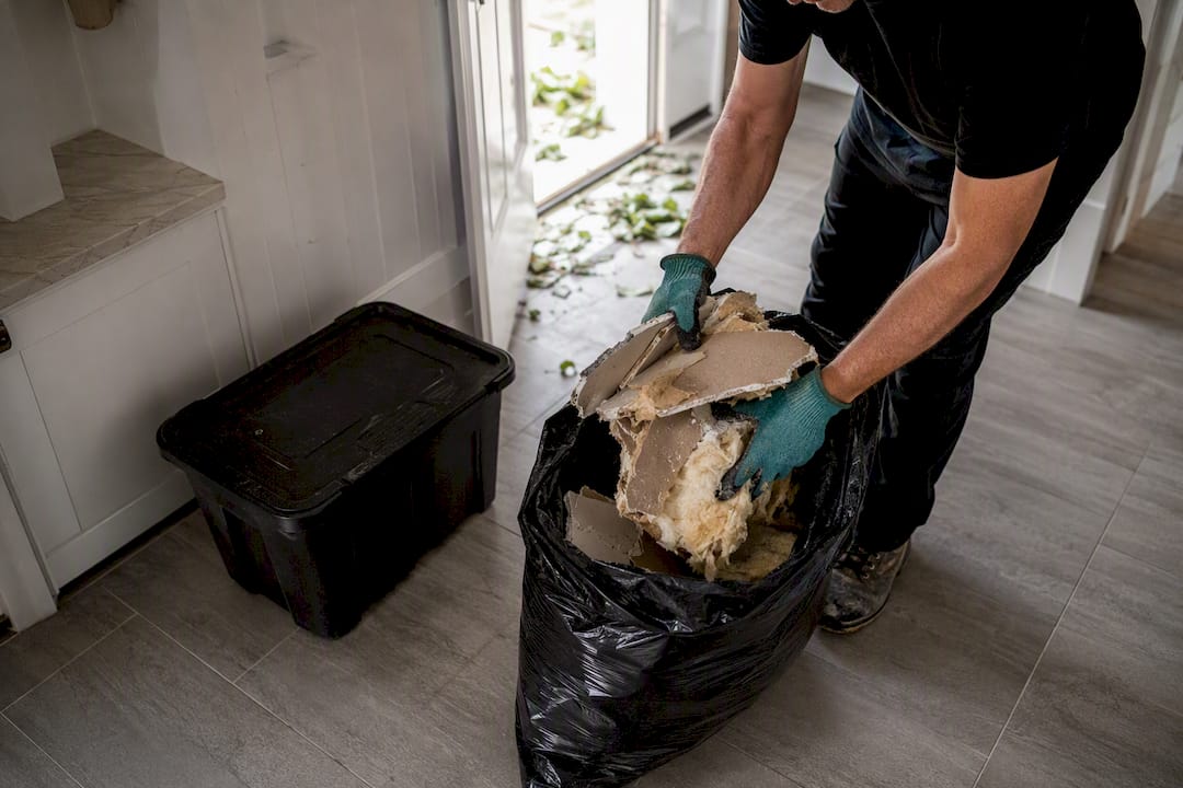 Wet drywall and insulation sealed in contractor bag