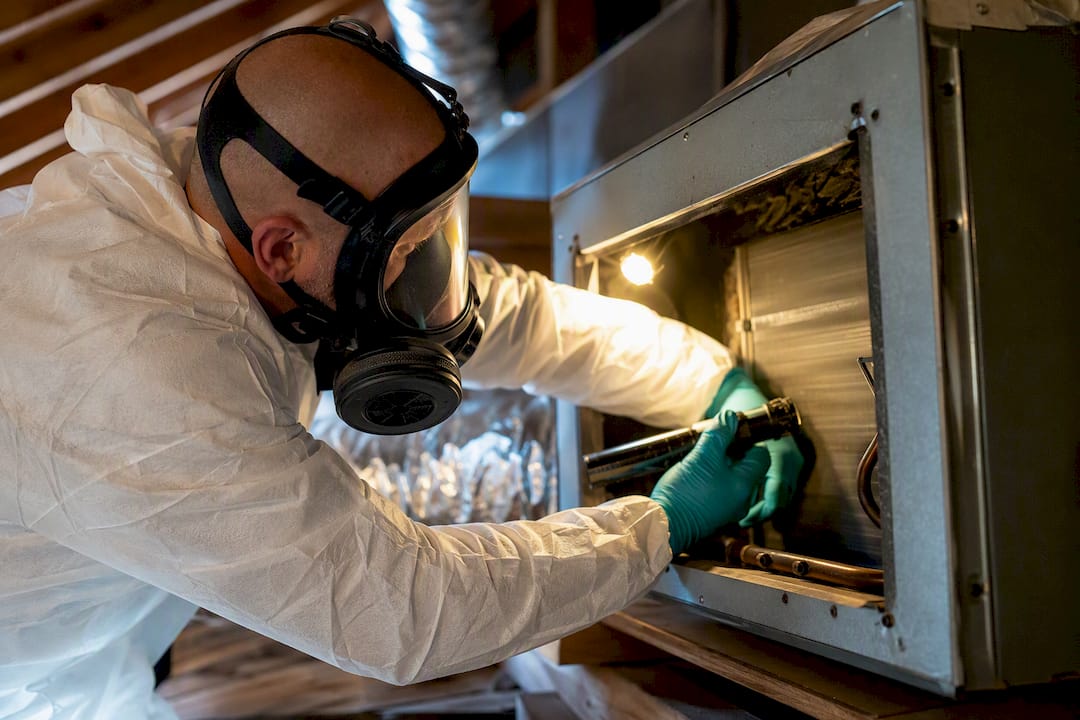 Technician accessing contaminated HVAC ductwork